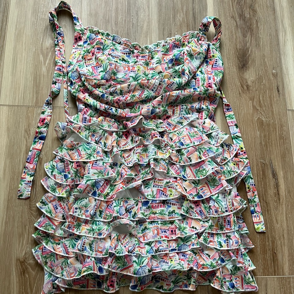 Fun little mini dress. Ruffled with open back. Size M.
